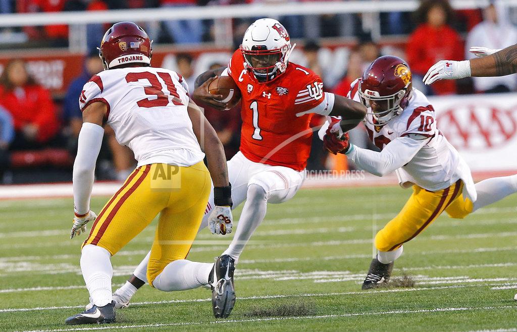 Rick Bowmer Utah quarterback Tyler Huntley (1) is tackled by Southern California's Hunter Echols, left, and John Houston Jr., center, during the first half of an NCAA college football game Saturday, Oct. 20, 2018, in Salt Lake City. (AP Photo/Rick Bowmer)