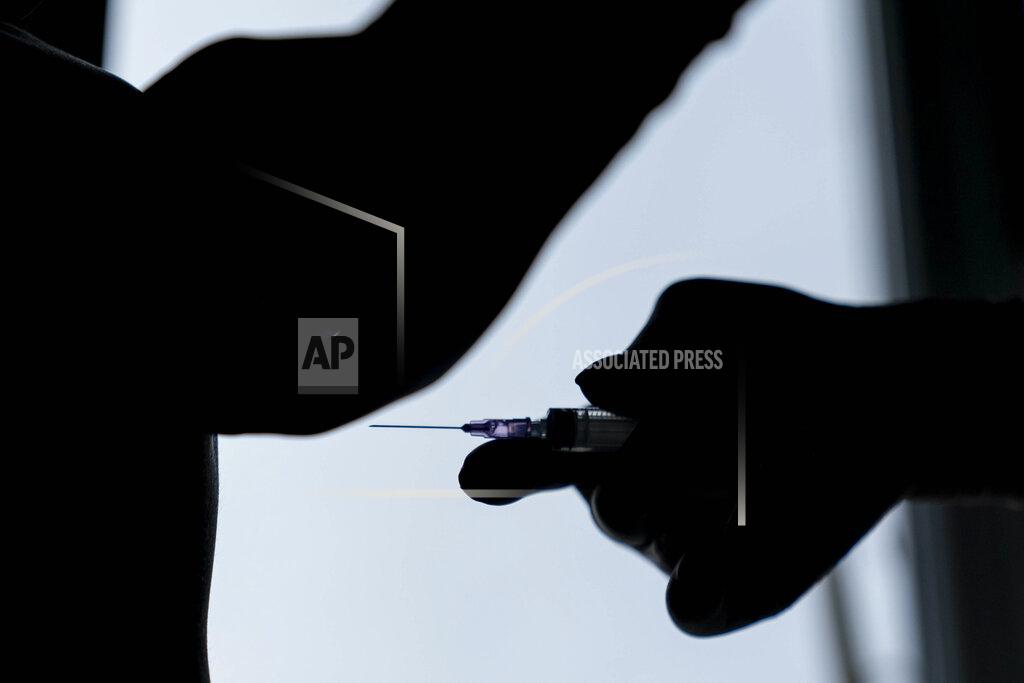 Evgeniy Maloletka A medic prepares to administer a dose of an AstraZeneca COVID-19 vaccine marketed under the name CoviShield, to a Ukrainian serviceman at a military base in Kramatorsk, Ukraine, Tuesday, March 2, 2021. Ukraine plans to vaccinate 14.4 million people this year, or about 35% of its 41 million people. (AP Photo/Evgeniy Maloletka)