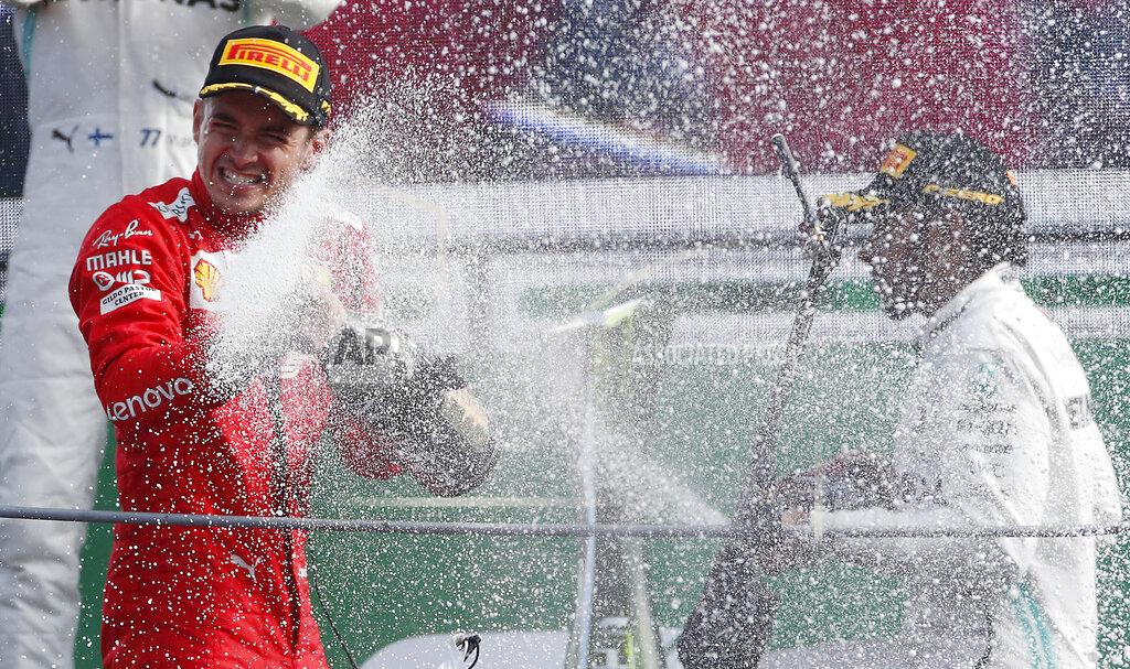Antonio Calanni Ferrari driver Charles Leclerc of Monaco, left, celebrates with third placed Mercedes driver Lewis Hamilton of Britain, on podium after winning the Formula One Italy Grand Prix at the Monza racetrack, in Monza, Italy, Sunday, Sept.8, 2019. (AP Photo/Antonio Calanni)