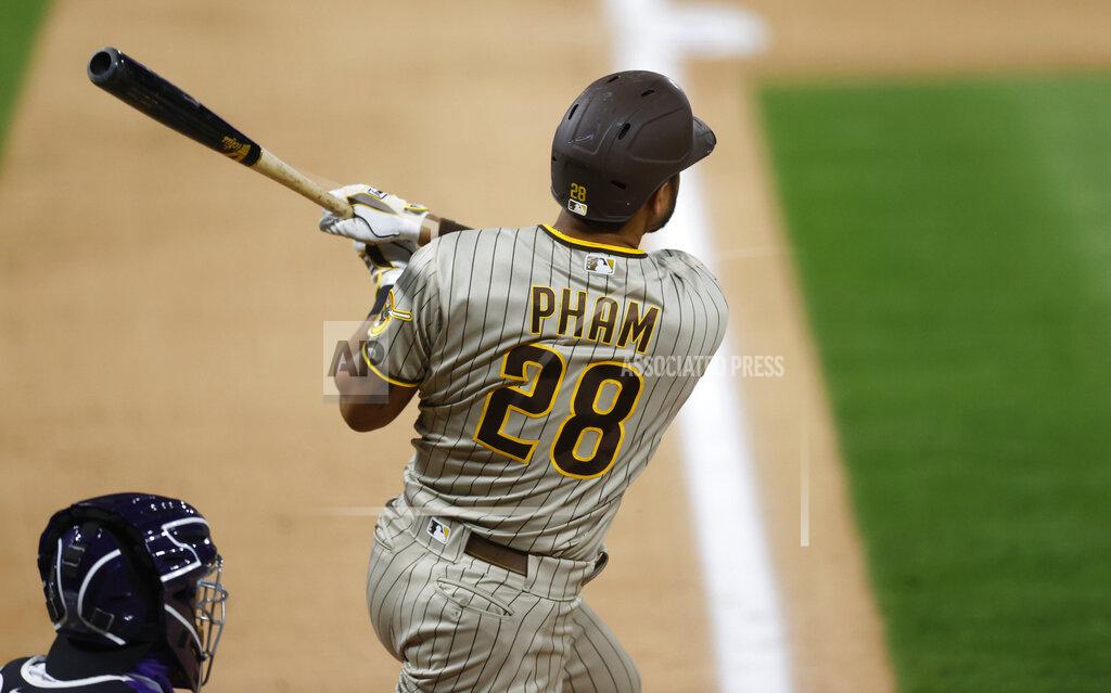 David Zalubowski San Diego Padres' Tommy Pham follows the flight of his three-run home run off Colorado Rockies relief pitcher Wade Davis in the ninth inning of a baseball game Friday, July 31, 2020, in Denver. (AP Photo/David Zalubowski)