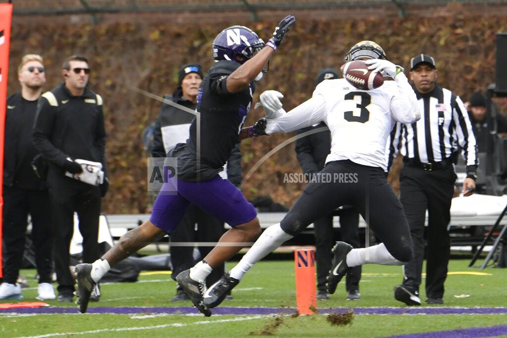 Paul Beaty Purdue wide receiver David Bell (3) attempts to catch a pass in the end zone while Northwestern's Cam Mitchell (2) defends during the second half of a NCAA college football game Saturday, Nov. 20, 2021, at Wrigley Field in Chicago. Mitchell was called for interference. (AP Photo/Paul Beaty)