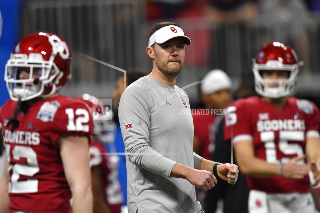 FILE - In this Saturday, Dec. 28, 2019, file photo, Oklahoma head coach Lincoln Riley speaks with his team before the first half of the Peach Bowl NCAA semifinal college football playoff game against LSU, in Atlanta. Riley already has coached Heisman Trophy winners Baker Mayfield and Kyler Murray along with Heisman runner-up Jalen Hurts. Now, he is hoping to build a new tradition at Oklahoma - pulling top quarterbacks to Oklahoma from the high school ranks. Caleb Williams, the No. 1 quarterback in the 247Sports Class of 2021 and ESPN’s No. 1 dual-threat quarterback for that class, has committed to OKlahoma.(AP Photo/John Amis, File)