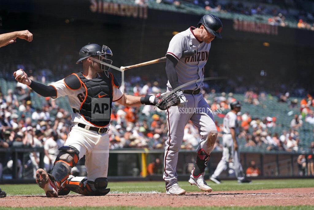Eric Risberg Arizona Diamondbacks' Carson Kelly walks back to the dugout after striking out swinging against San Francisco Giants starting pitcher Kevin Gausman during the seventh inning of a baseball game Thursday, June 17, 2021, in San Francisco. At left is Giants catcher Curt Casali. (AP Photo/Eric Risberg)