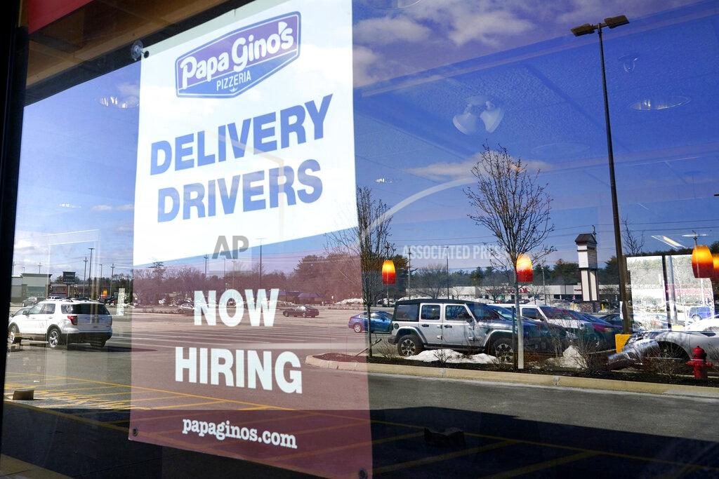 A "Now Hiring" sign is displayed, Thursday, March 4, 2021, in Salem, N.H. U.S. employers added a surprisingly robust 379,000 jobs in February in a sign the economy is strengthening as virus cases drop, vaccinations ramp up, Americans spend more and states ease business restrictions. (AP Photo/Elise Amendola)