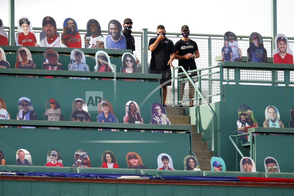 Michael Dwyer Boston Red Sox employees stand in the Green Monster seats with cutouts of former players and fans before an opening day baseball game between the Red Sox and the Baltimore Orioles at Fenway Park, Friday, July 24, 2020, in Boston. (AP Photo/Michael Dwyer)