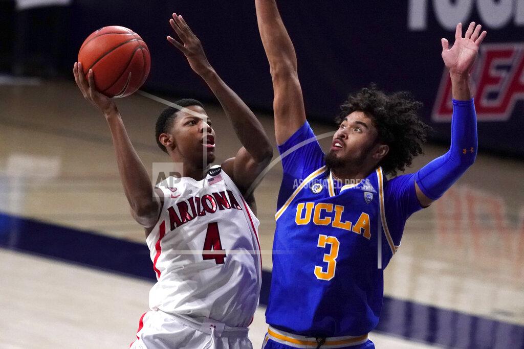 Rick Scuteri Arizona guard Dalen Terry (4) shoots over UCLA guard Johnny Juzang during the first half of an NCAA college basketball game, Saturday, Jan. 9, 2021, in Tucson, Ariz. (AP Photo/Rick Scuteri)