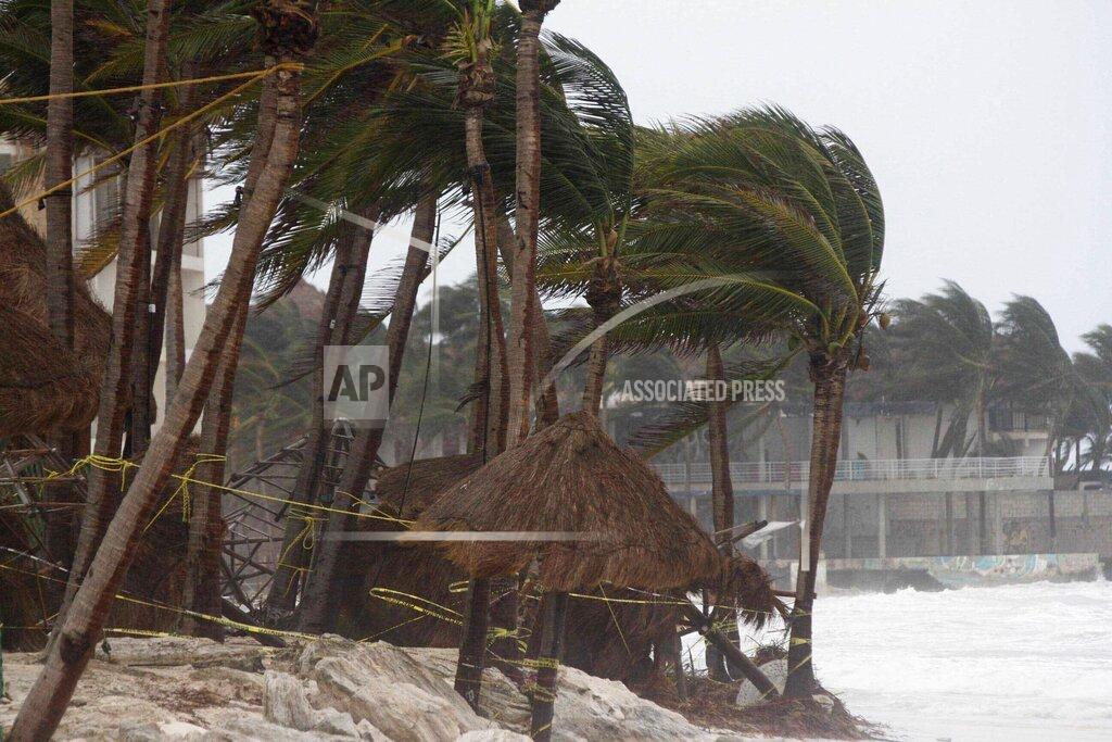 Tomas Stargardter Palm trees are buffeted by the winds of Hurricane Zeta in Playa del Carmen, Mexico, early Tuesday, Oct. 27, 2020. Zeta is leaving Mexico’s Yucatan Peninsula on a path that could hit New Orleans Wednesday night. (AP Photo/Tomas Stargardter)