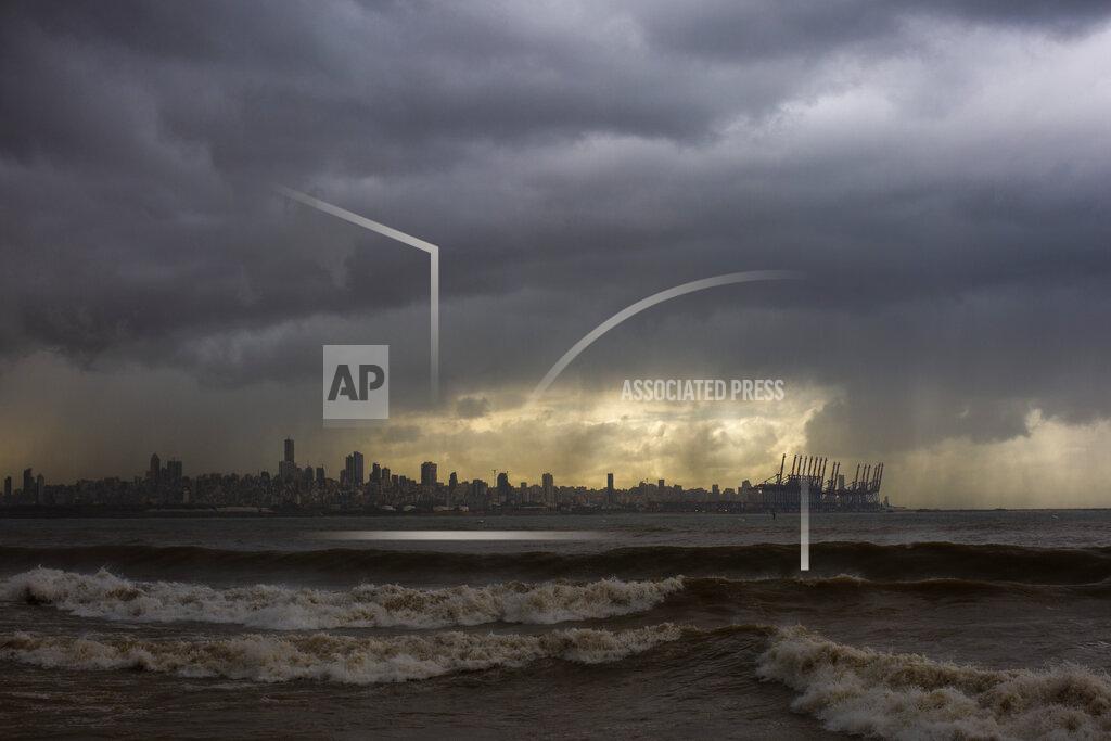 Hassan Ammar Heavy clouds hover over Beirut as waves crash on the seawall of the corniche, in Dbayeh, Lebanon, Wednesday, Feb. 17, 2021. Storm Joyce hit late Tuesday with gale force winds registering up to 100 km/h (62 miles/h). (AP Photo/Hassan Ammar)
