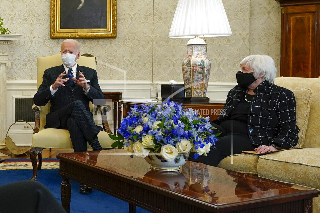 President Joe Biden, accompanied by Vice President Kamala Harris and Treasury Secretary Janet Yellen, meets with business leaders to discuss a coronavirus relief package in the Oval Office of the White House, Tuesday, Feb. 9, 2021, in Washington. (AP Photo/Patrick Semansky)