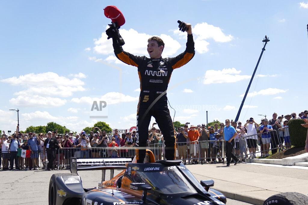 Pato O'Ward celebrates after winning the second race of the IndyCar Detroit Grand Prix auto racing doubleheader on Belle Isle in Detroit, Sunday, June 13, 2021. (AP Photo/Paul Sancya)