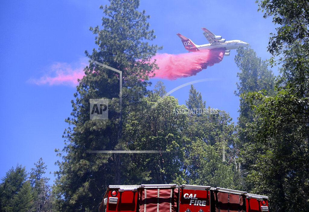 Elias Funez A type 1 air tanker makes a large retardant drop along a line of the Golden Fire south of Camptonville, Calif. Friday, May 20, 202. (Elias Funez/The Union via AP)