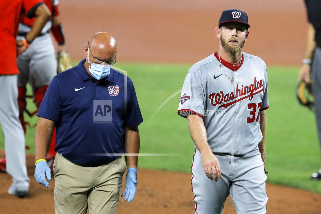 Julio Cortez Washington Nationals starting pitcher Stephen Strasburg, right, walks with a member of the training staff as he heads to the dugout after leaving the game during the first inning of a baseball game against the Baltimore Orioles, Friday, Aug. 14, 2020, in Baltimore. (AP Photo/Julio Cortez)