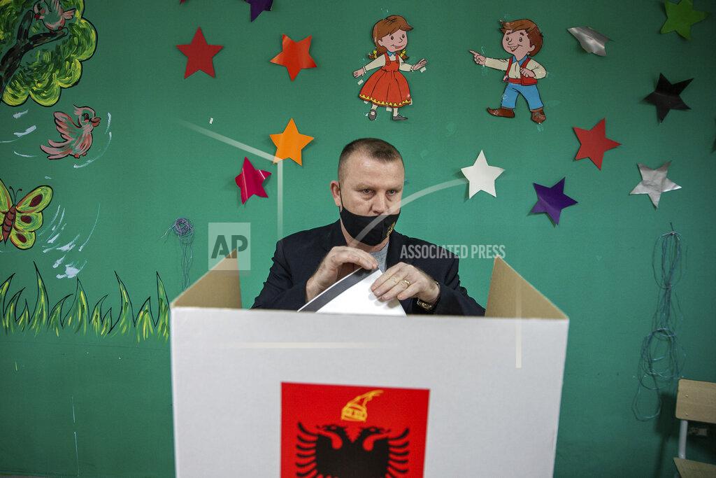Visar Kryeziu An Albanian man casts folds his ballot during parliamentary elections in capital Tirana, Albania, Sunday, April 25, 2021. Albanian voters have started casting ballots in parliamentary elections on Sunday amid the virus pandemic and a bitter political rivalry between the country's two largest political parties. (AP Photo/Visar Kryeziu)