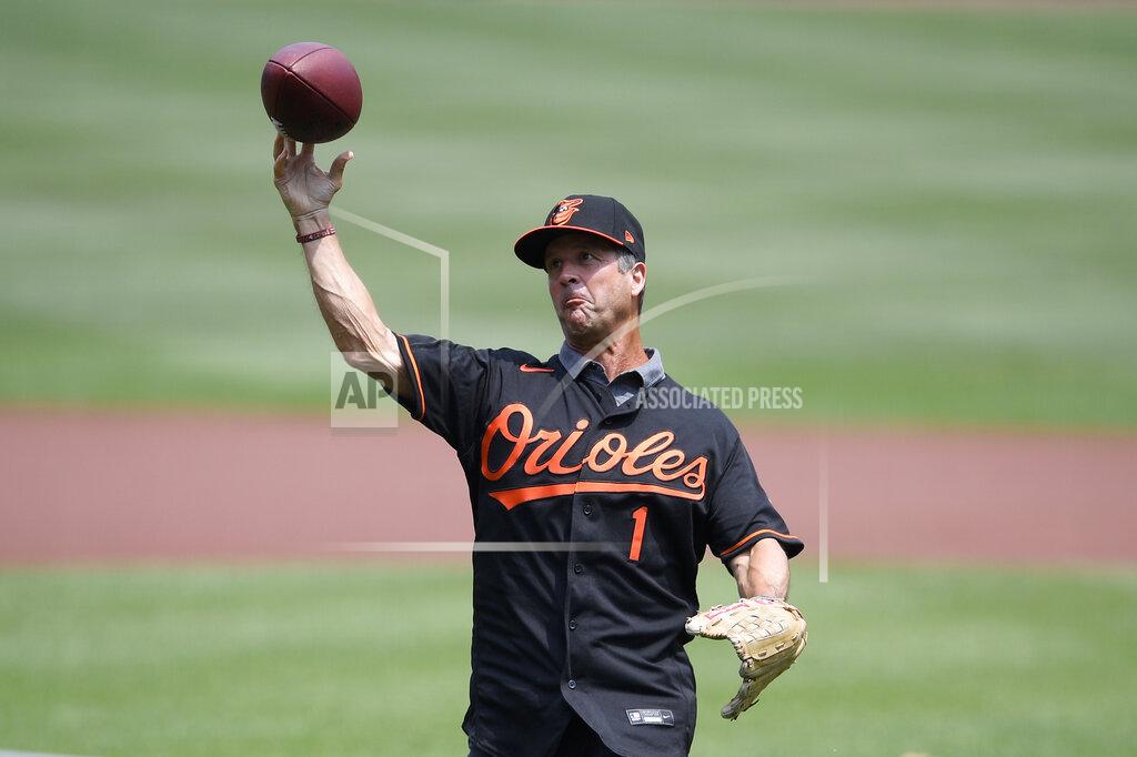 Nick Wass Baltimore Ravens head football coach John Harbaugh throws out the ceremonial first pitch using a football before a baseball game between the Baltimore Orioles and the Washington Nationals, Sunday, July 25, 2021, in Baltimore. (AP Photo/Nick Wass)