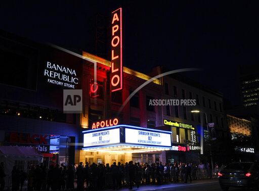 FILE - People line up at the Apollo Theater, the venue for the U2 SiriusXM concert in New York on June 11, 2018. BET announced that the 33rd annual Soul Train Awards, which honors the best in soul, hip hop and rhythm and blues music, will be taped at the Apollo and premiere on BET and BET Her on Sunday, Nov. 28. (Photo by Evan Agostini/Invision/AP, File)