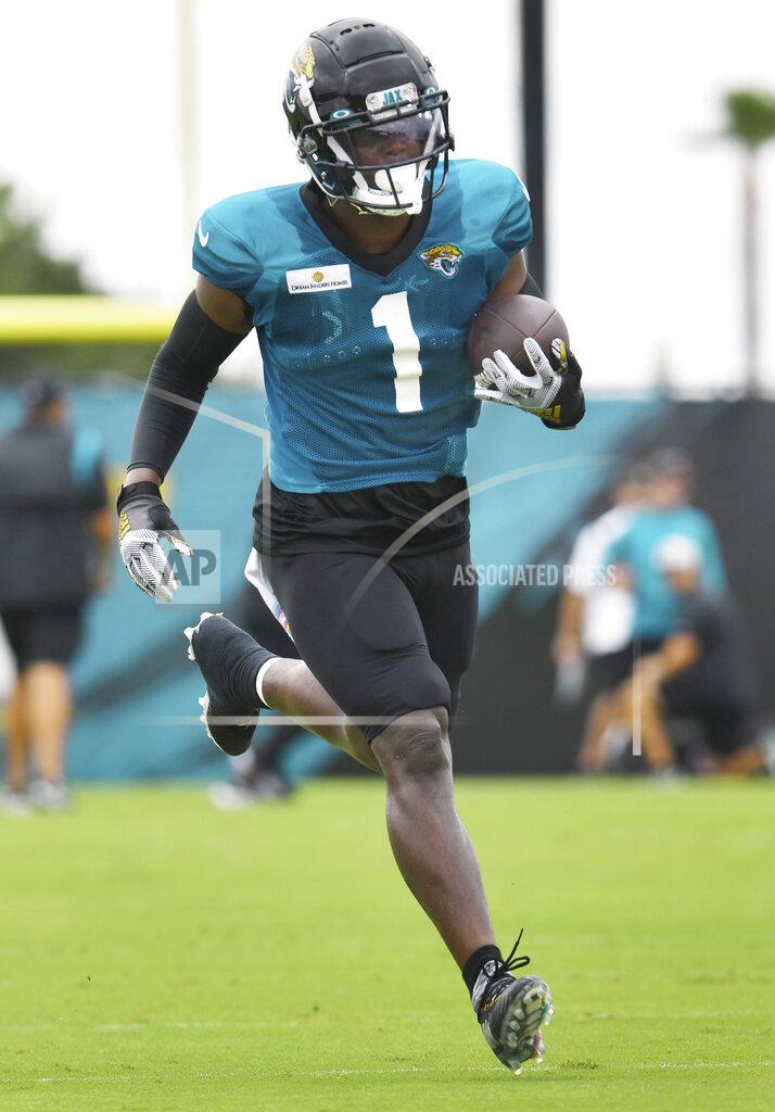 Bob Self Jacksonville Jaguars' Travis Etienne Jr. runs with the ball after making a catch during an NFL football training camp in Jacksonville, Fla., Tuesday, Aug. 3, 2021. (Bob Self/The Florida Times-Union via AP)