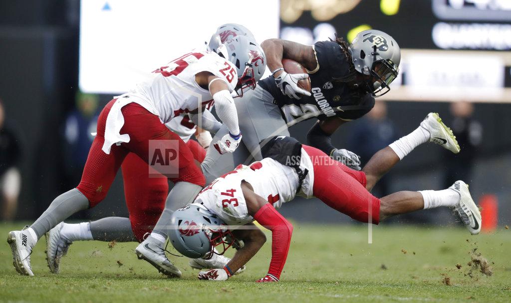 David Zalubowski Colorado wide receiver Laviska Shenault Jr., back right, is tackled by Washington State safety Jalen Thompson, front, right, and safety Skyler Thomas after pulling in a pass in the second half of an NCAA college football game Saturday, Nov. 10, 2018, in Boulder, Colo. Washington State won 31-7. (AP Photo/David Zalubowski)