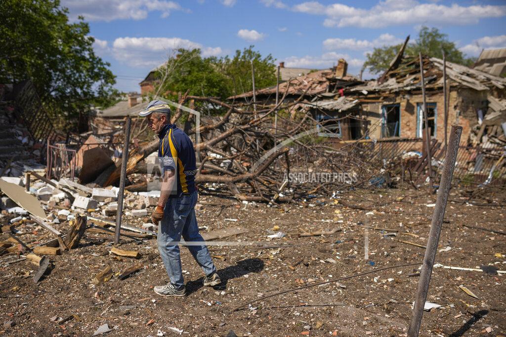 Francisco Seco A local resident stands next to a house destroyed in a Russian bombing in Bakhmut, eastern Ukraine, Tuesday, May 24, 2022. The town of Bakhmut has been coming under increasing artillery strikes, particularly over the last week, as Russian forces try to press forward to encircle the city of Sieverodonetsk to the northeast. (AP Photo/Francisco Seco)