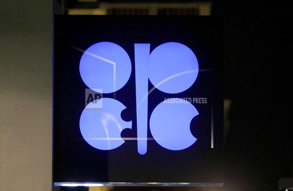FILE - In this Dec. 19, 2019 file photo, the advertising label of the Organization of the Petroleum Exporting Countries, OPEC, shines at their headquarters in Vienna, Austria. OPEC and allied countries including Russia agreed Thursday, Dec. 3, 2020 to increase oil production by 500,000 barrels a day from January and said they would meet monthly to decide further output levels, gingerly adding more crude to a global economy still suffering from the COVID-19 pandemic. (AP Photo/Ronald Zak, File)