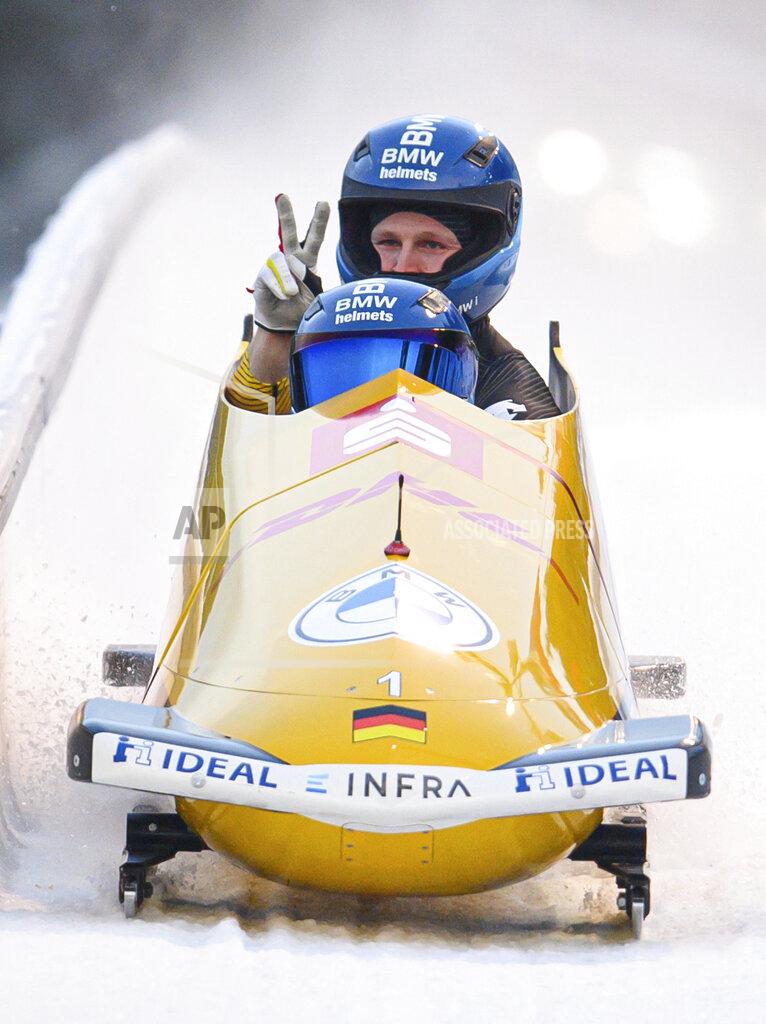 Robert Michael Francesco Friedrich and Alexander Schueller from Germany cross the finish line after winning the two-man-world cup in Altenberg, Germany, Saturday, Dec. 4, 2021. (Robert Michael/dpa via AP)