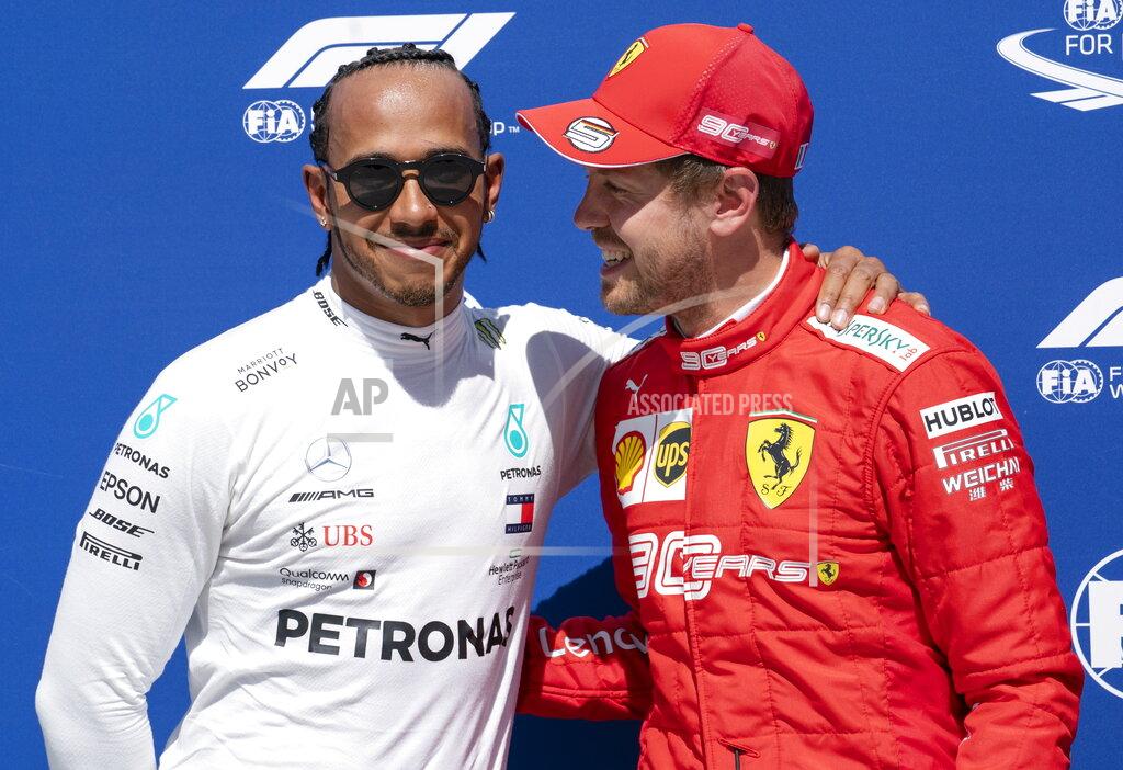 Paul Chiasson Mercedes driver Lewis Hamilton, left, of Great Britain congratulates Ferrari driver Sebastian Vettel of Germany for taking the pole position during qualifying for the Formula One Canadian Grand Prix auto race in Montreal, Saturday, June 8, 2019. (Paul Chiasson/The Canadian Press via AP)