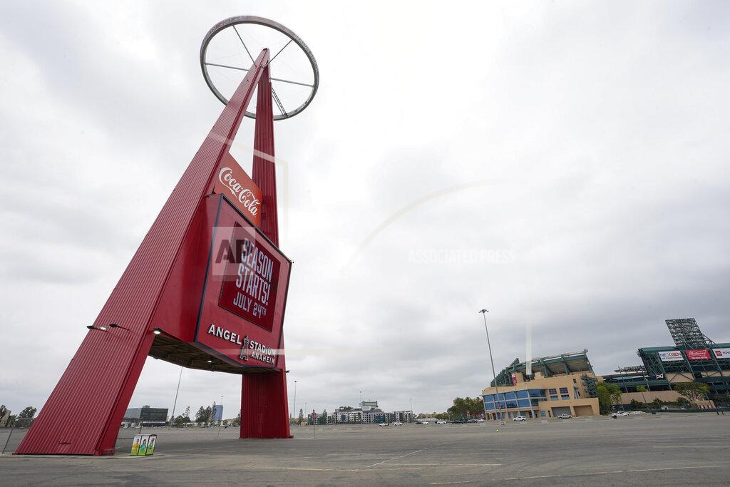 Ashley Landis A sign outside Angels Stadium announces Opening Day as July 24, on Wednesday, July 1, 2020, in Anaheim, Calif. The Angels and other Major League Baseball teams will report to their respective facilities for training this week, amid the coronavirus pandemic. (AP Photo/Ashley Landis)