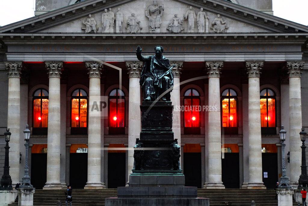 Matthias Schrader Red lamps burn at the longtime closed Opera house in Munich, Germany, Sunday, Dec. 6, 2020. Bavaria intensifies measures to contain the corona crisis from Dec. 9, 2020. (AP Photo/Matthias Schrader)