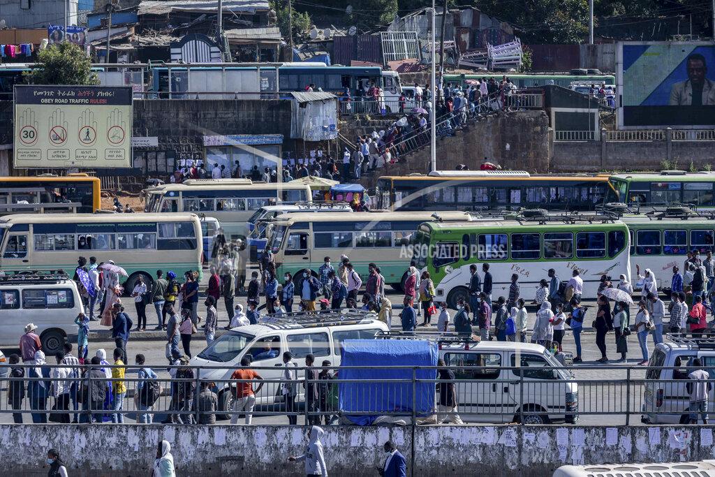 Mulugeta Ayene Passengers queue to get on buses in the capital Addis Ababa, Ethiopia Friday, Nov. 6, 2020. Ethiopia's prime minister says airstrikes have been carried out against the forces of the country's Tigray region, asserting that the strikes in multiple locations "completely destroyed rockets and other heavy weapons." (AP Photo/Mulugeta Ayene)