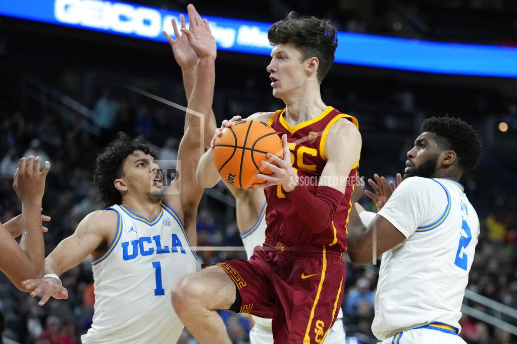 John Locher Southern California's Drew Peterson (13) passes around UCLA's Jules Bernard (1) during the second half of an NCAA college basketball game in the semifinal round of the Pac-12 tournament Friday, March 11, 2022, in Las Vegas. (AP Photo/John Locher)