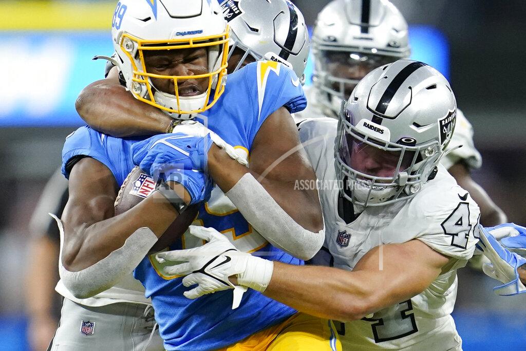 Marcio Jose Sanchez Los Angeles Chargers tight end Donald Parham is hauled down by Las Vegas Raiders inside linebacker Nick Kwiatkoski, right, and others during the first half of an NFL football game Monday, Oct. 4, 2021, in Inglewood, Calif. (AP Photo/Marcio Jose Sanchez)