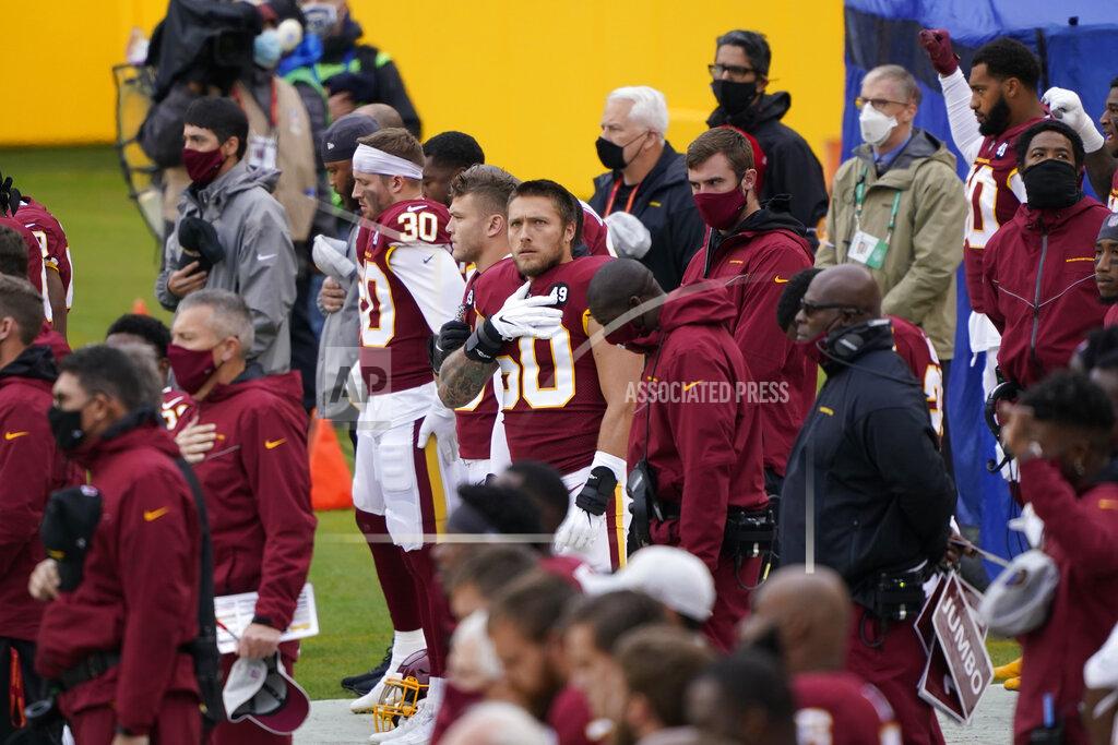 Susan Walsh Members of the Washington Football Team on the sidelines before the start of the first half of an NFL football game against Dallas Cowboys, Sunday, Oct. 25, 2020, in Landover, Md. (AP Photo/Susan Walsh)