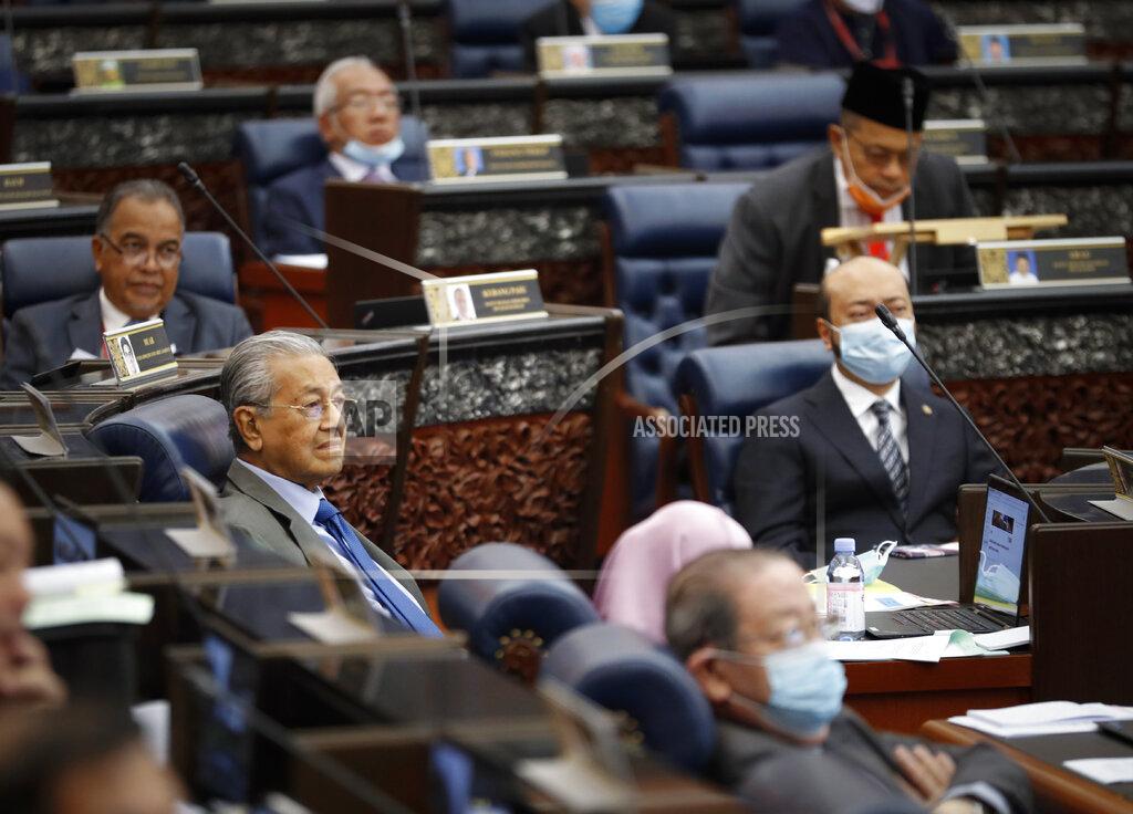 Vincent Thian Former Prime Minister Mahathir Mohamad, left, attend a session of the lower house of parliament in Kuala Lumpur, Malaysia, Monday, July 13, 2020. (AP Photo/Vincent Thian)