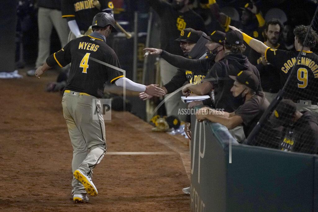 Tony Avelar San Diego Padres' Wil Myers (4) is congratulated by teammates after scoring a run on a double by Trent Grisham during the fifth inning against the Oakland Athletics in a baseball game in Oakland, Calif., Friday, Sept. 4, 2020. (AP Photo/Tony Avelar)