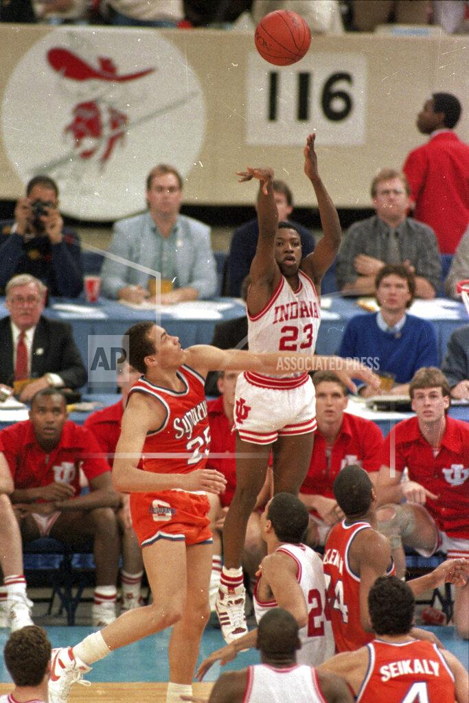 Bill Haber FILE - In this file photo taken March 30, 1987, Indiana's Keith Smart (23) fires a shot past Syracuse's Howard Triche for a basket, putting Indiana ahead by one point in the final seconds of the NCAA college basketball championship game in New Orleans. Indiana defeated Syracuse 74-73. (AP Photo/Bill Haber, File)