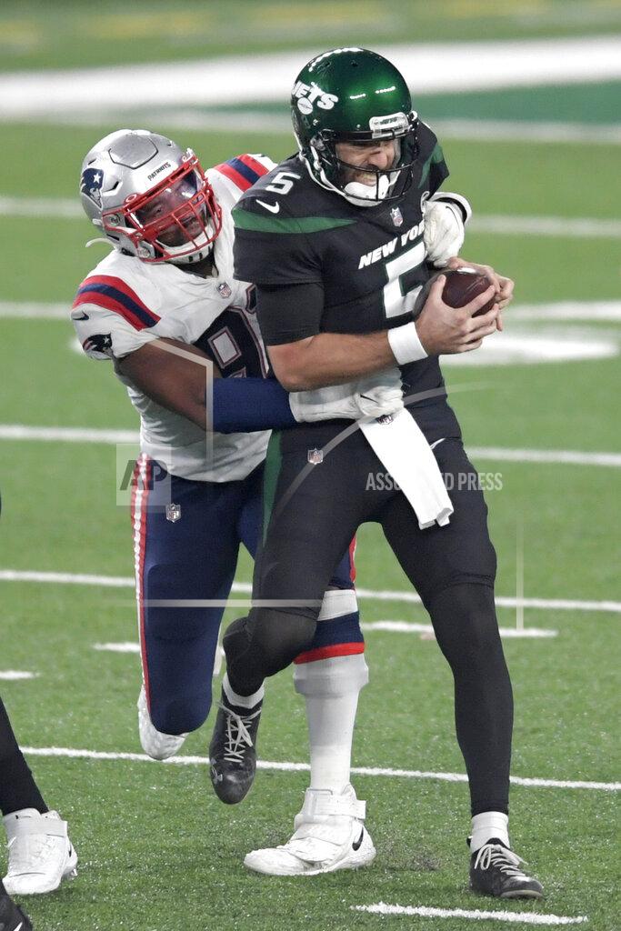 Bill Kostroun New York Jets quarterback Joe Flacco, right, is sacked by New England Patriots' Deatrich Wise during the second half of an NFL football game, Monday, Nov. 9, 2020, in East Rutherford, N.J. (AP Photo/Bill Kostroun)