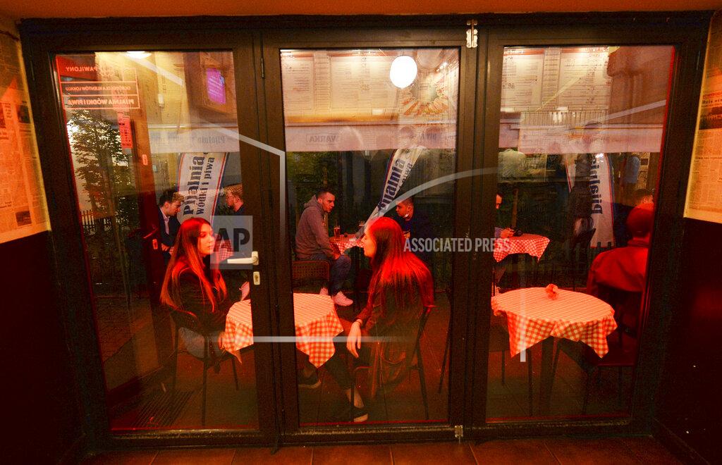Czarek Sokolowski People gather and celebrate as bars, clubs and other establishments reopened in Poland after being closed for seven months, in Warsaw, Poland, Friday, May 14, 2021. (AP Photo/Czarek Sokolowski)