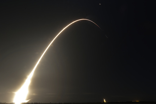 FILE - This time exposure photo shows a SpaceX Falcon 9 rocket, with a payload including two lunar rovers from Japan and the United Arab Emirates, launching from Launch Complex 40 at the Cape Canaveral Space Force Station in Cape Canaveral, Fla., on Dec. 11, 2022. But later in April 2023, the spacecraft from a Japanese company apparently crashed while attempting to land on the moon. Japan now hopes to make the world's first &quot;pinpoint landing&quot; on the moon early Saturday, Jan. 20, 2024, joining a modern push for lunar contact with roots in the Cold War-era space race between the United States and the Soviet Union. (AP Photo/John Raoux, File)