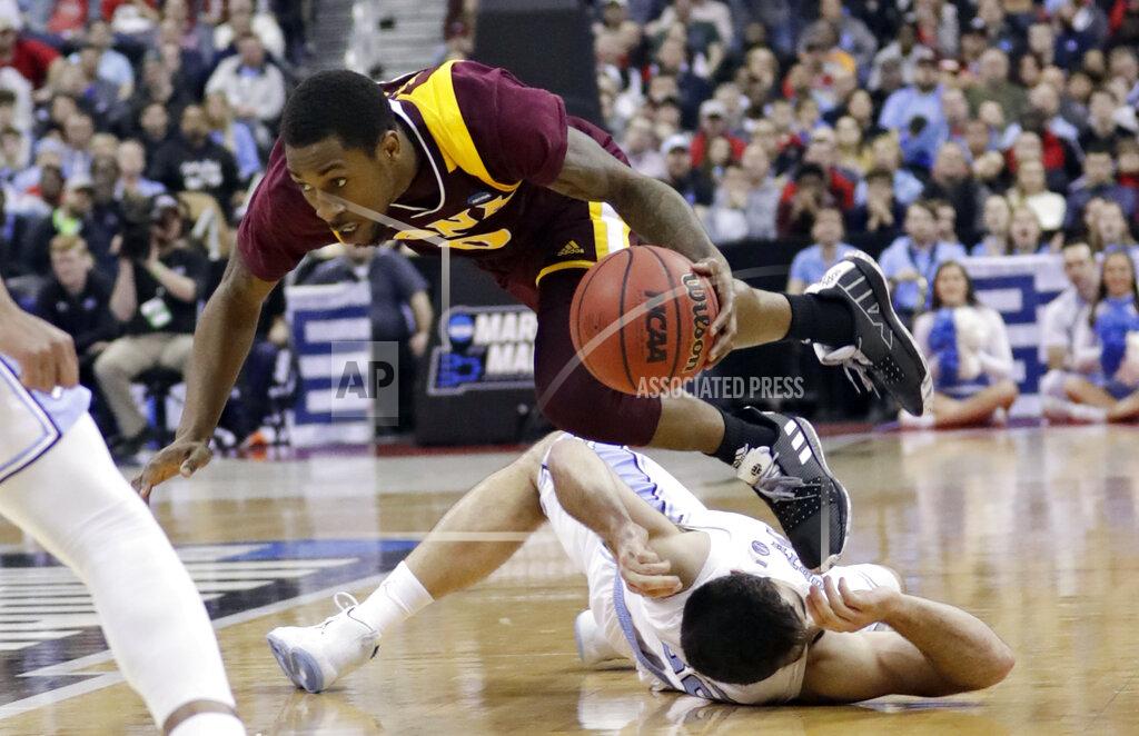 Tony Dejak North Carolina's Seventh Woods, top, jumps over Iona's Payton Hudson during the second half of a first-round game in the NCAA men’s college basketball tournament in Columbus, Ohio, Friday, March 22, 2019. North Carolina won 88-73. (AP Photo/Tony Dejak)