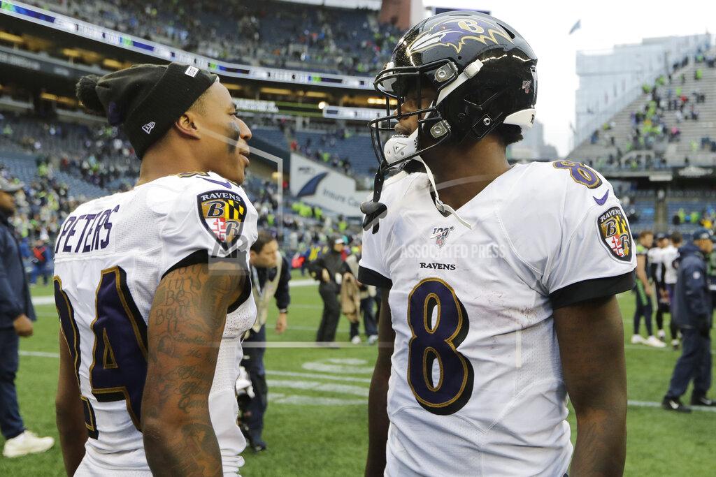 John Froschauer Baltimore Ravens quarterback Lamar Jackson (8) alks with cornerback Marcus Peters (24) after an NFL football game against the Seattle Seahawks, Sunday, Oct. 20, 2019, in Seattle. (AP Photo/John Froschauer)
