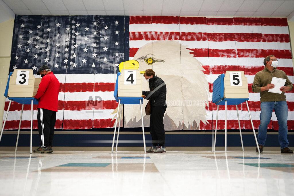 Steve Helber CORRECTS MONTH TO NOVEMBER Voters cast their ballots under a giant mural at Robious Elementary school in Midlothian, Va., Tuesday Nov. 3, 2020. Poll workers said that traffic was slow due to all the early voting in the precinct. (AP Photo/Steve Helber)