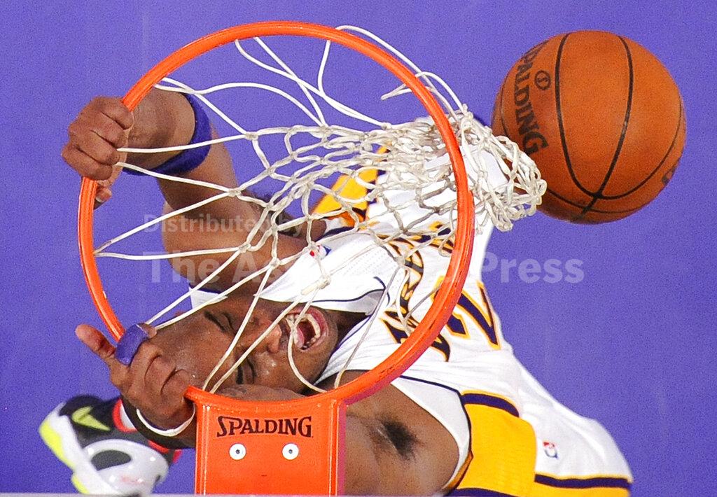FILE - In this April 10, 2011, file photo, Los Angeles Lakers guard Kobe Bryant dunks during the first half of an NBA basketball game against the Oklahoma City Thunder, in Los Angeles. Bryant, the 18-time NBA All-Star who won five championships and became one of the greatest basketball players of his generation during a 20-year career with the Los Angeles Lakers, died in a helicopter crash Sunday, Jan. 26, 2020. (AP Photo/Mark J. Terrill, File)