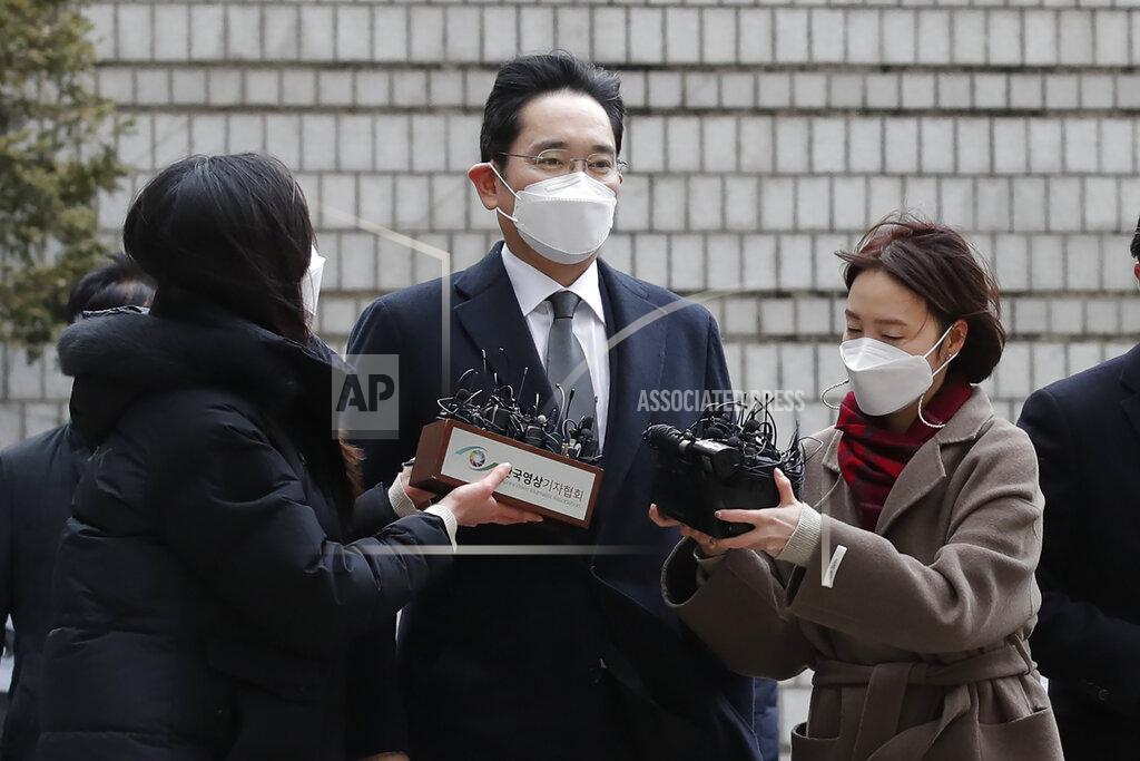 Lee Jin-Man Samsung Electronics Vice Chairman Lee Jae-yong, center, is questioned by reporters upon his arrival at the Seoul High Court in Seoul, South Korea, Monday, Jan. 18, 2021. Lee was sent back to prison on Monday after a South Korean court sentenced him to two and a half years over his involvement in a 2016 corruption scandal that spurred massive street protests and ousted South Korea’s then-president. (AP Photo/Lee Jin-man)