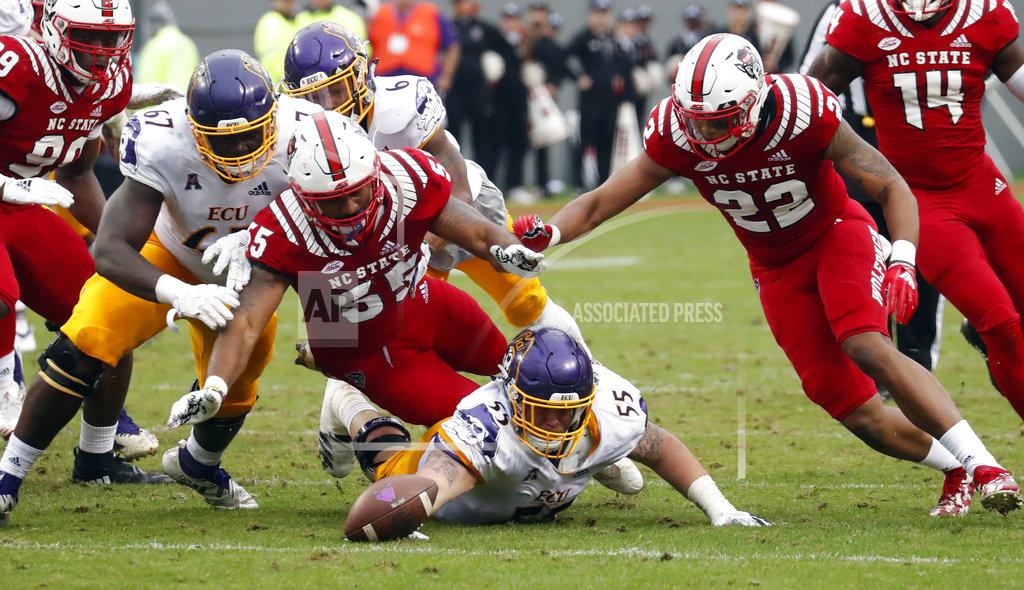 Chris Seward North Carolina State's Deonte Holden (55) and Isaiah Stallings (22) battle East Carolina's D'Ante Smith (67) and Garrett McGhin (55) for a fumble during the second half of NCAA college football game in Raleigh, N.C., Saturday, Dec. 1, 2018. N.C. State recovered the ball. (AP Photo/Chris Seward)