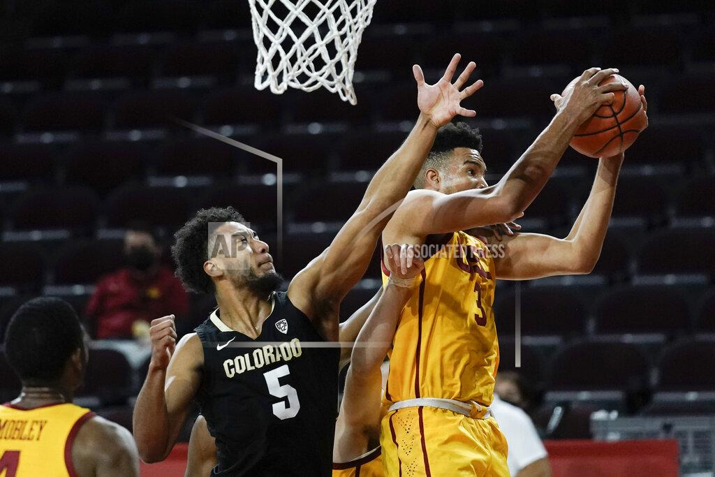 Jae C. Hong Southern California's Isaiah Mobley, right, gets a rebound next to Colorado's D'Shawn Schwartz during the first half of an NCAA college basketball game Thursday, Dec. 31, 2020, in Los Angeles. (AP Photo/Jae C. Hong)