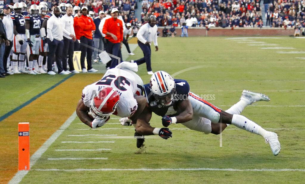 Bob Andres Georgia running back Brian Herrien (35) scores a touchdown, defended by Auburn defensive back Noah Igbinoghene (4) during the second quarter of an NCAA college football game, Saturday, Nov. 16, 2019, in Auburn, Ala. Georgia won 21-14. (Bob Andres/Atlanta Journal-Constitution via AP)