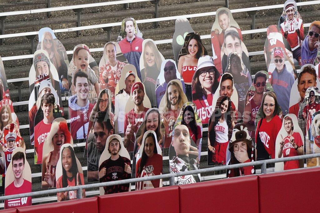 Cardboard cutouts are seen in the seats before an NCAA college football game between Wisconsin and Indiana Saturday, Dec. 5, 2020, in Madison, Wis. (AP Photo/Morry Gash)