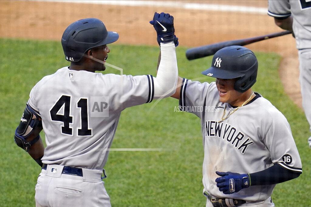 Jim Mone New York Yankees' Miguel Andujar (41) congratulates Gio Urshela on his solo home run off Minnesota Twins pitcher J.A. Happ (33) during the fourth inning of a baseball game Thursday, June 10, 2021, in Minneapolis. (AP Photo/Jim Mone)