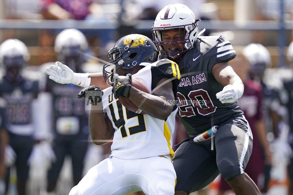 Rogelio V. Solis Arkansas-Pine Bluff running back Mattias Clark (45) is tackled for a loss by Alabama A&M linebacker Armoni Holloway (20) during the first half of the Southwestern Athletic Conference NCAA college football game, Saturday, May 1, 2021, in Jackson, Miss. (AP Photo/Rogelio V. Solis)