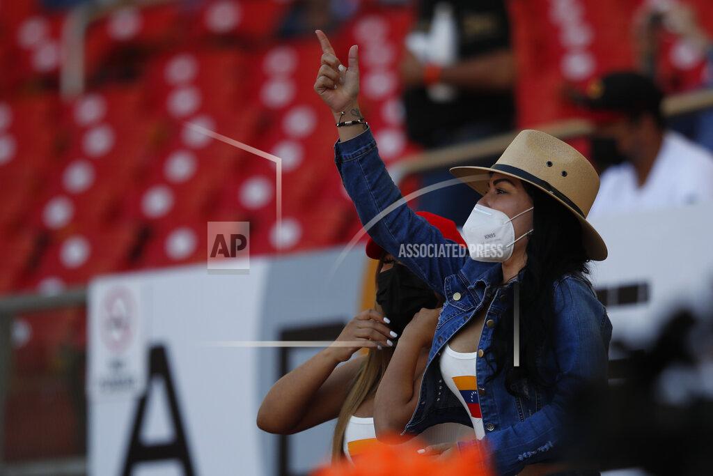 Moises Castillo A fan of Venezuela wearing a face mask, cheers for her team during a Caribbean Series baseball game against Panama at Teodoro Mariscal Stadium in Mazatlan, Mexico, Sunday, Jan. 31, 2021. (AP Photo/Moises Castillo)