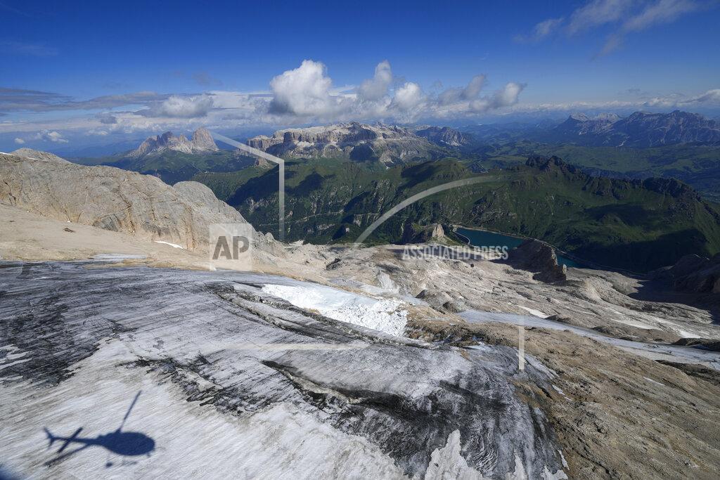 Luca Bruno A view taken from a rescue helicopter of the Punta Rocca glacier near Canazei, in the Italian Alps in northern Italy, Tuesday, July 5, 2022, two day after a huge chunk of the glacier broke loose, sending an avalanche of ice, snow, and rocks onto hikers. (AP Photo/Luca Bruno)